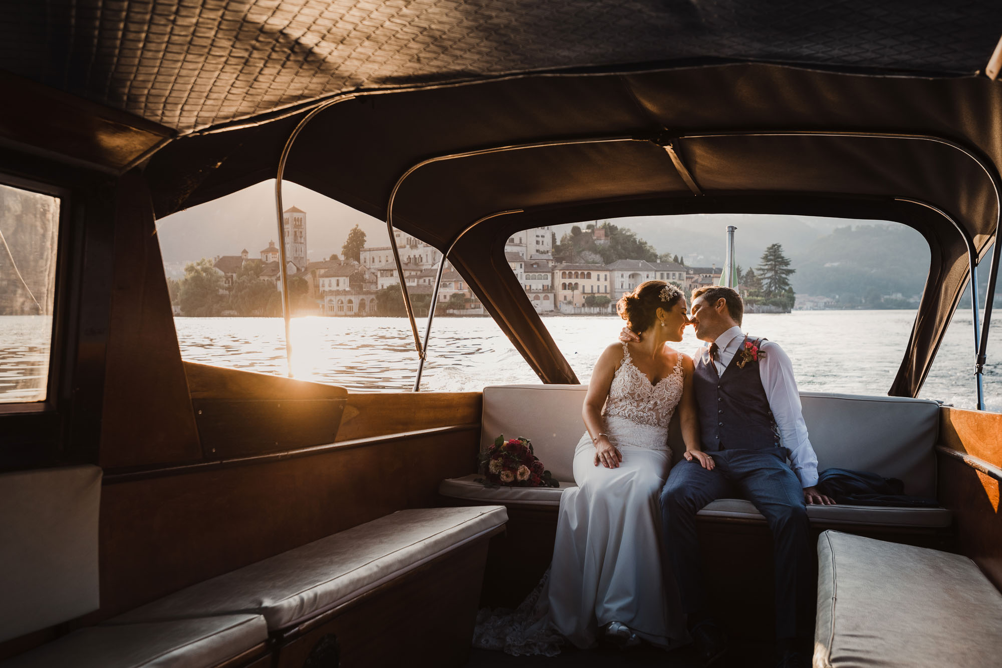 Lake Orta wedding photographer, bride and groom on boat at Lake Orta Italy