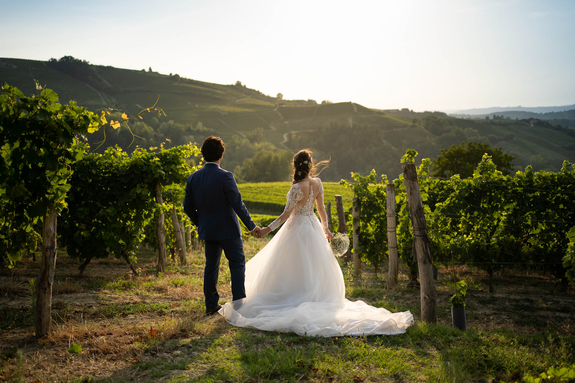 Bride and groom looking at the amazing Piedmont sunset in the Monferrato vineyards